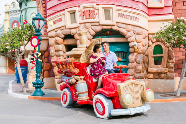 Couple posing for engagement photos in Toontown at Disneyland