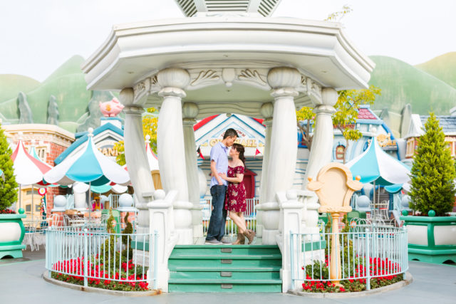 Couple posing for engagement photos in Toontown at Disneyland