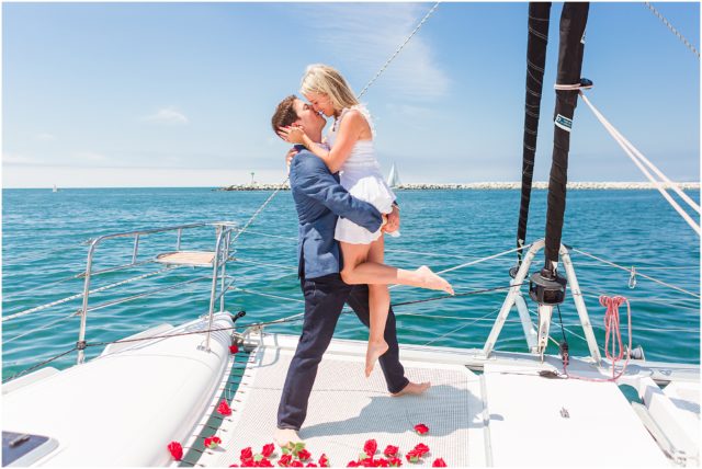 Newly engaged couple embracing on sail boat - Surprise Sailboat Engagement in Marina Del Rey