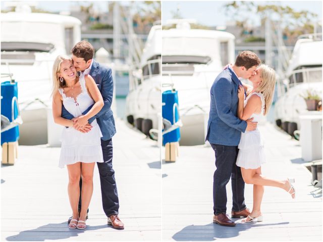 Newly engaged couple embracing on dock in marina