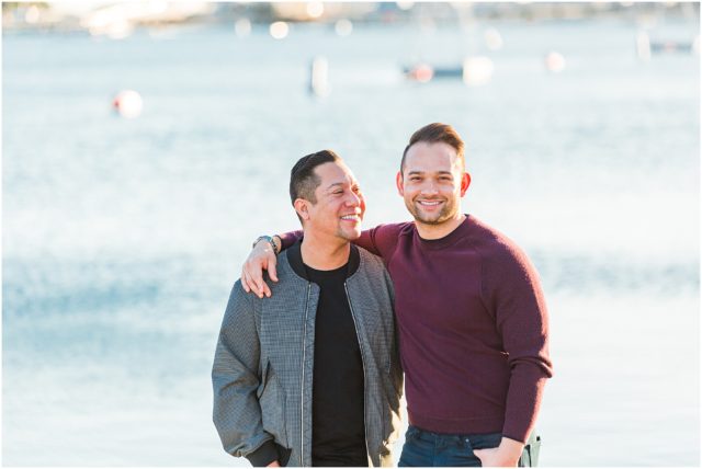 Grooms posing for engagement session on the sand in the marina in Long Beach at sunset.
