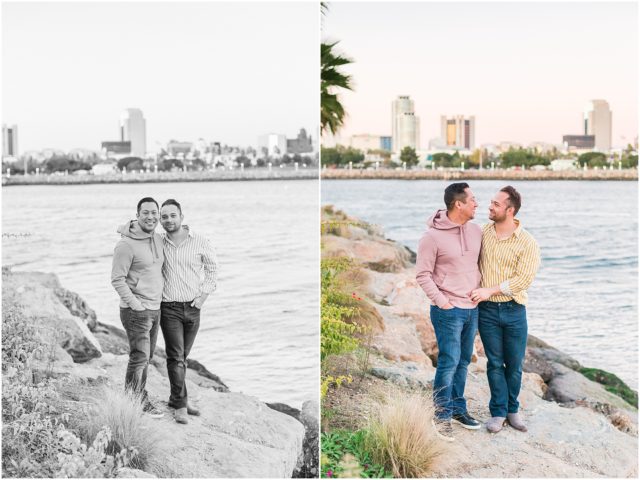 Same sex couple posing on rock cliff overlooking the marina in Long Beach at sunset.