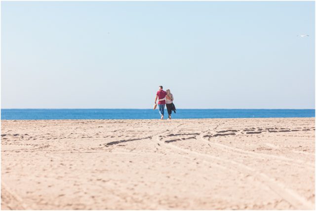 Man with girlfriend walking on beach
