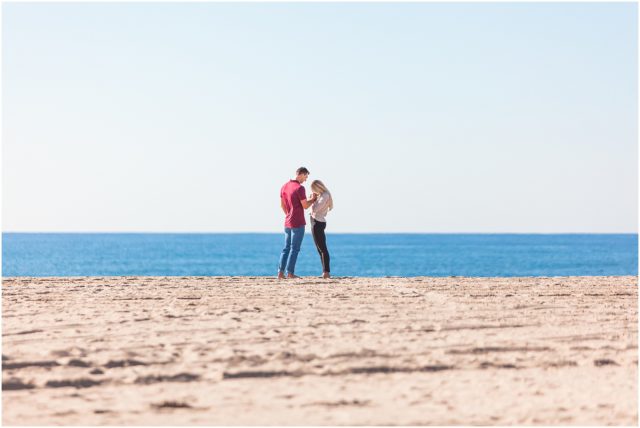 Man proposing to girlfriend surprise beach engagement proposal in Santa Monica in the sand