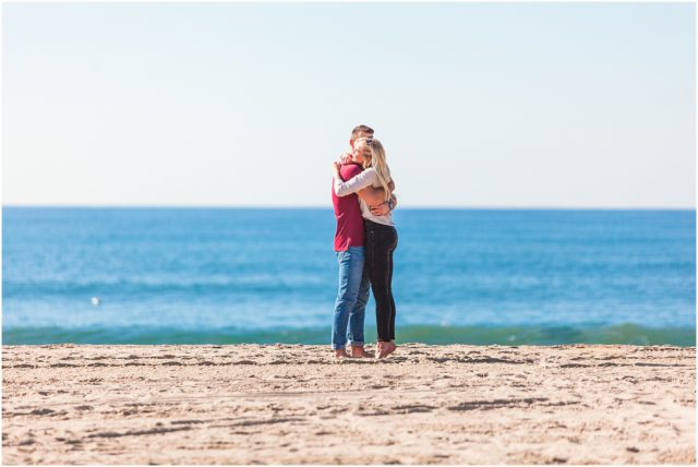 Man proposing to girlfriend surprise beach engagement proposal in Santa Monica in the sand