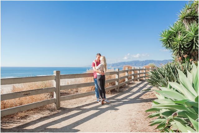 Newly engaged couple posing at their surprise beach engagement session in Santa Monica 