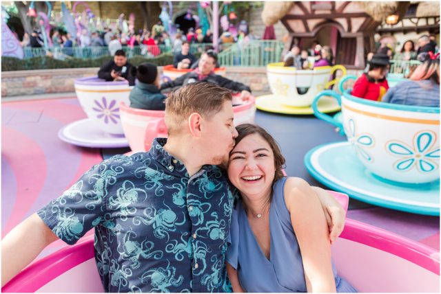 Couple posing for engagement session  on Teacup Ride in Fantasyland at Disneyland Park.