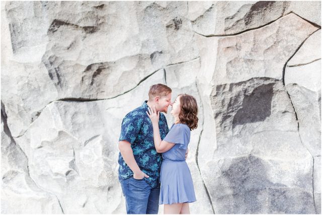 Couple posing for engagement session  in front of Matterhorn at Disneyland Park.