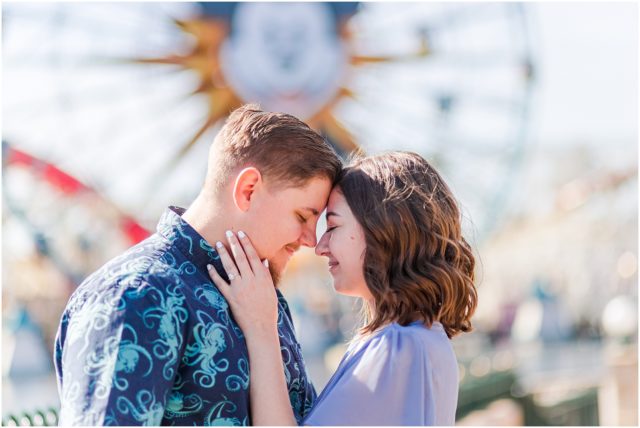 Couple posing for engagement session  on Pixar Pier at Disneyland Park.