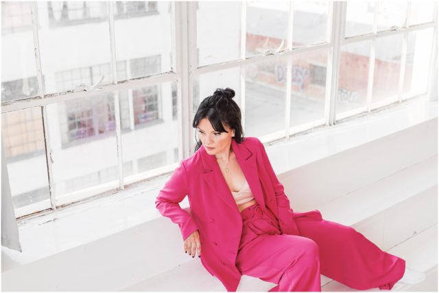 Natalie Clark Music Promo Portrait Session in studio in DTLA in hot pink pantsuit