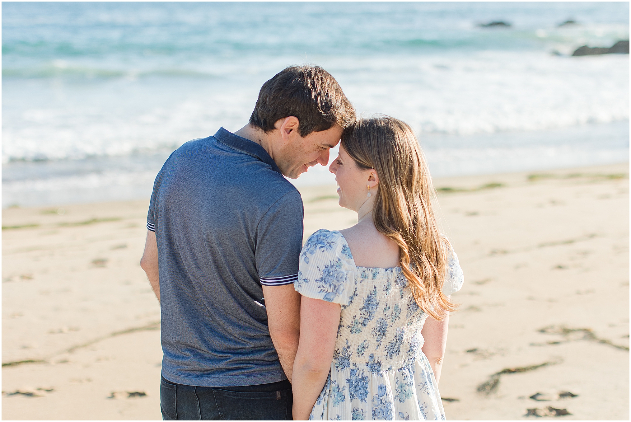 An Irvine Cove Engagement Session in Laguna Beach at golden hour. This lovely couple play on the beach in the golden sunset.
