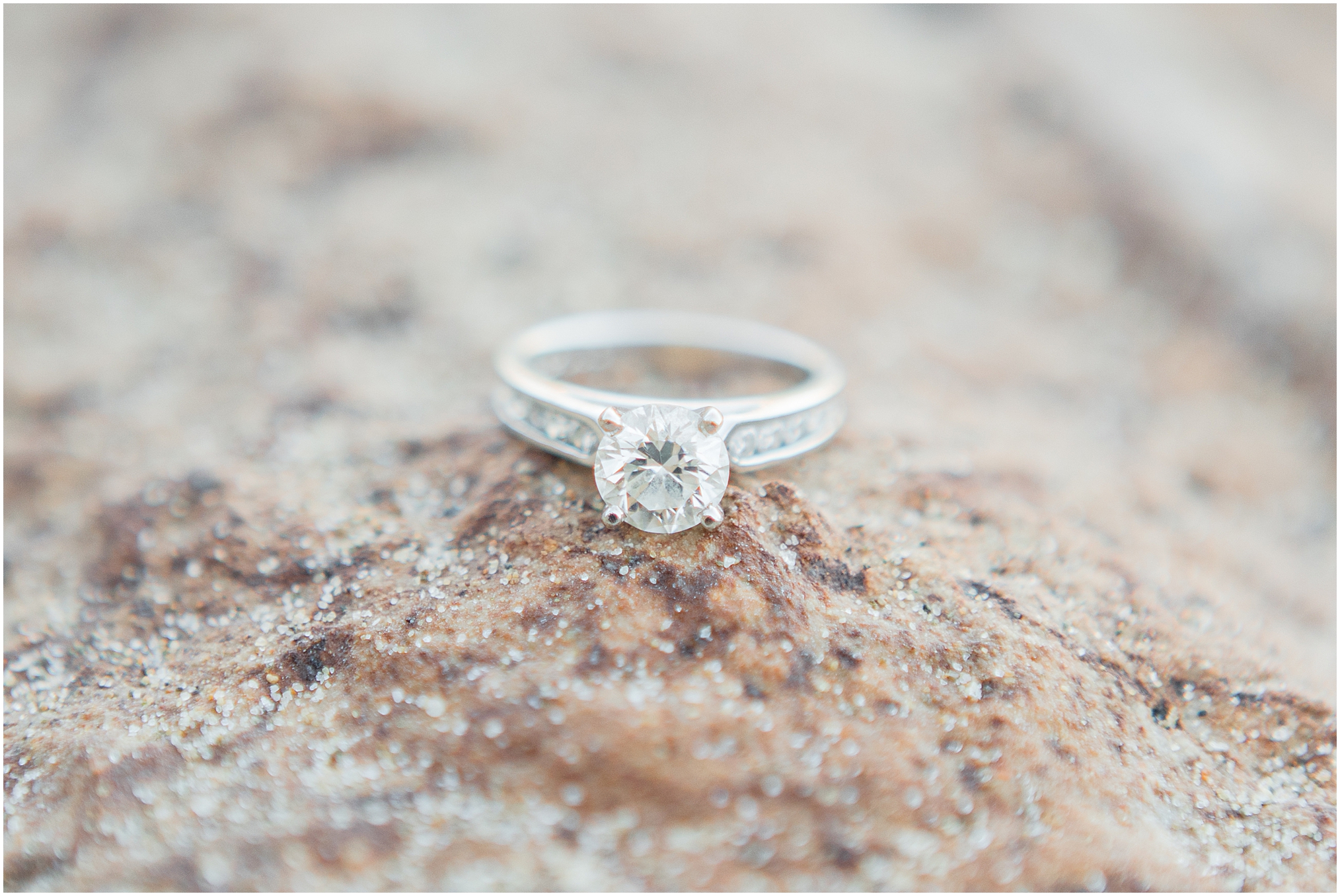 Macro shot of engagement ring. An Irvine Cove Engagement Session in Laguna Beach at golden hour. This lovely couple play on the beach in the golden sunset.
